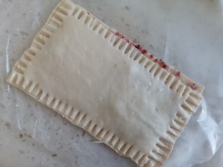 5、蓝莓派,把另外一个皮盖上，用勺子封住边角