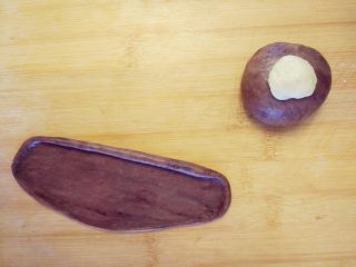 5、维尼熊跳跳虎挤挤小面包,其中一块加少许可可粉，揉匀后分成两部分，一部分团成球，另一部分擀成长条薄片，边缘卷起