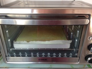 10、菠菜小蛋糕,将拌好的蛋糕糊倒入铺了油纸的烤盘里，在桌面上震出气泡，放入提前预热到180度的烤箱烘烤18分钟左右