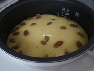 13、电饭锅戚风蛋糕,时间到,继续焖5分钟,再开盖,可以明显看到,做好的蛋糕比刚才倒入的蛋糕糊足足高了3CM,把内胆取出倒扣在晾架上。