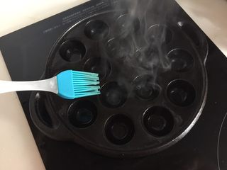 11、章鱼小丸子,预热好后刷上油，上面没有洞的地方也刷上