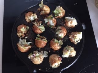 16、章鱼小丸子,然后再用竹签滚一半，材料用竹签边滚边塞进去，不要马上整个半圆滚进去，这样待会会剩下半圆而已，慢慢地边滚边收进去就可以