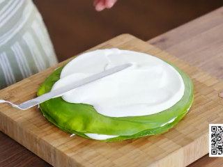 12、抹茶千层蛋糕,取一张饼,铺上打发奶油,用刮刀抹平,再叠上下一张,依次进行直至完成千层蛋糕