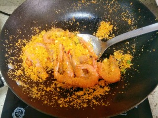 11、避风塘炒虾,加入明虾翻炒，均匀的裹上面包糠即可