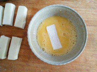 15、论牛奶的各种吃法之――脆皮炸鲜奶,将鸡蛋打散成蛋液，将粘了裹炸粉的奶冻条蘸一层均匀的蛋液。