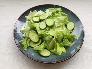 4、鲜虾胡柚沙拉,将生菜和黄瓜装盘备用。