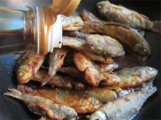 8、家乡特色美食——杂鱼炖小豆饼,另起一锅，倒入煎炸好的小鱼，再放入适量生抽，喜欢重口味的可以滴几滴老抽