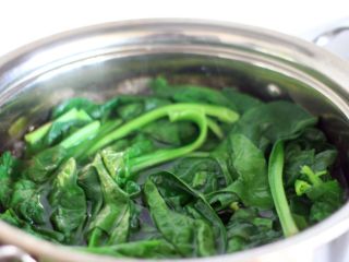 3、凉拌菠菜塔,放入菠菜,烫一下,颜色变深之后捞出。