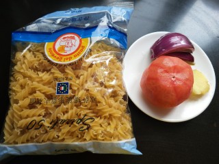 2、茄汁螺旋意面,准备意面，番茄，洋葱，生姜，并洗净，番茄去皮。