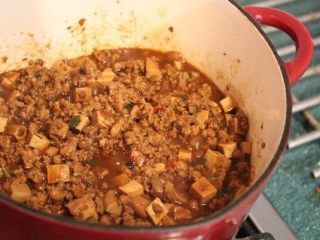 8、炸酱,煮滚后﹐盖盖,转小火炖半个小时。