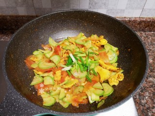 13、番茄炒西葫芦,放入小葱翻炒均匀。