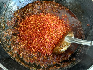 12、麻辣底料,辣椒面放入翻炒，此时会比较稠了，注意勤翻炒