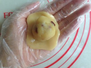 8、小鱼儿蔓越莓绿豆月饼,冰皮压扁放上馅料，将饼皮慢慢向上推收口