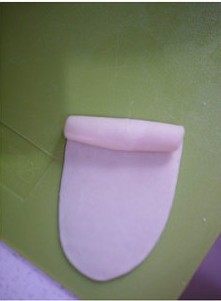 5、黑芝麻酥皮月饼,包好后取一只剂子,擀开成椭圆型,自上而下卷起。