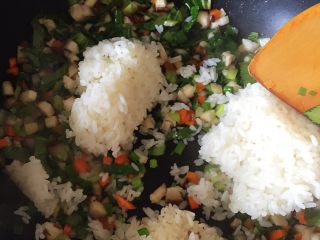 5、老干妈炒饭,倒入米饭一块翻炒，打米饭的饭块炒开，因我蒸的米饭较硬，隔夜又蒸发了一些水分，跟菜一起翻炒刚好吸收菜里的水分就刚刚好了