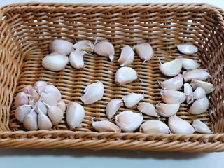 2、自制蒜蓉辣酱,将蒜头掰成一瓣一瓣的。