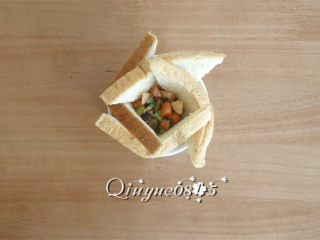 2、早餐面包盏,把炒出的菜用勺子舀进去一点儿。