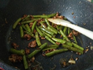 11、干煸豆角,继续翻炒。