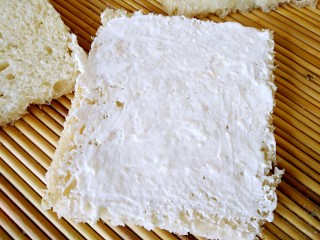 7、全麦土司三明治,取一片土司，均匀抹上奶酪