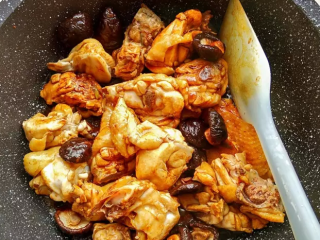 3、香菇板栗烧鸡,然后加入蚝油、料酒、老抽、盐、糖，翻炒均匀。再加入香菇稍微炒几下。