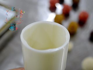 6、好看好玩又好做的颜值担当——桃山皮月饼,模具桶内也撒上面粉，滚动模具使面粉均匀分布在模具壁上。然后磕掉多余面粉，装入花片，上紧。装入我们揉好的月饼坯