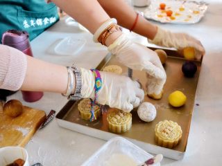 8、好看好玩又好做的颜值担当——桃山皮月饼,模具上有两个小耳朵一样的地方，可以卡住我们的手指，整个模具压在烤盘上之后，先整体向下压到按不动。然后拇指向下推的同时，食指和中指向上提。