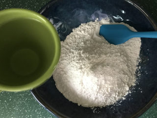 2、炒元宵,将刚烧好的开水分次加入糯米粉中，边加边搅拌