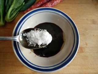 6、腊味煲仔饭,在调好的料汁中加入5克白糖搅匀。