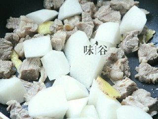 6、萝卜牛腩煲,再倒入萝卜翻炒。