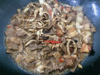 6、农家小煲笋,在煸炒的水气差不多没了，我们倒入高汤两碗或水都行。加入桂皮及香叶各一片，并加入调味。烧煮至水干即可