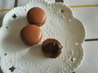 15、法式法芙娜可可马卡龙,夹馅料,把另外一片马卡龙放上去,放冰箱冷藏再食用。