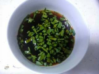 4、酱料汁香煎豆腐,用一个小碗，放入自制剁椒、姜蒜末、适量淀粉、生抽，拌匀，加入适量凉白开、放入蒜末叶子，搅拌均匀，调成酱料汁待用