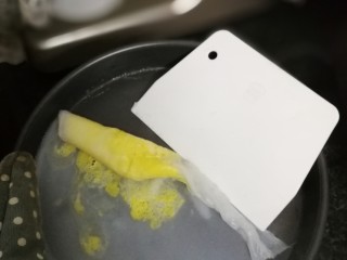 8、刮肠粉,戴防烫手套取出，用刮板把肠粉边刮边卷