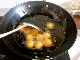8、香炸红薯丸子,炸的时候要不断的搅拌，让红薯球受热均匀，红薯球比较重，它自己不会翻个儿，元宵比较轻，炸元宵的时候，元宵会飘起来然后自己翻个儿，红薯丸子需要人工翻个儿。
