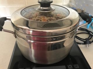 21、腊肠煲仔饭,把装好腊肠糯米的盆子放入蒸锅，大火烧开后，小火蒸制60分钟
