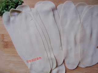 4、饺子皮变身油泼面,两拇指边轻轻往两头揉搓边抻扯，直至把饺子片抻扯成薄薄的长条