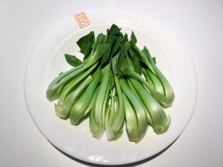 2、红烧狮子头,准备两颗青菜分别从根部切四半，菜叶稍作修剪，洗净待用；