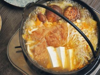 2、韩式菌菇肥牛暖锅,加入娃娃菜、金针菇、豆腐和面筋。