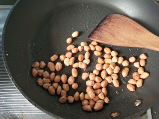 7、凉拌木耳黄瓜,热锅凉油,放入花生米,小火慢炒,炒香后盛出放入盘中凉凉。