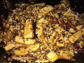 11、香辣豆干,趁着余温，倒入豆干。用勺子轻轻拌匀，不要用力，豆干会烂的。