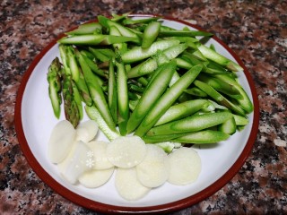 2、芦笋炒肉片,将芦笋、大蒜切成片。