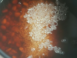 11、赤小豆玉米青豆饭,把淘洗好的大米倒到电饭锅里；