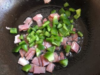 8、培根炒饭,加入青椒粒炒至断生