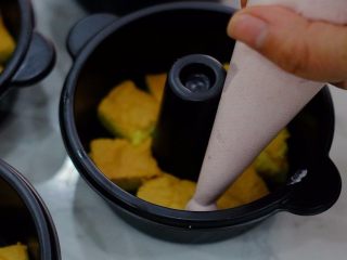 10、火锅慕斯,在铺好一层蛋糕胚的模具里挤上一层草莓慕斯，然后再放一层蛋糕胚，再挤上一层慕斯，挤完后放冰箱冷藏30分钟左右