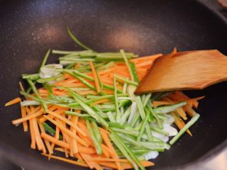 9、牛肉炒乌冬面,放入青椒和胡萝卜翻炒30秒。