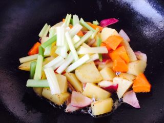 12、＃食二星座＃ 罐焖牛肉（34图详细步骤）,当土豆煎至表面有微微的金黄色时放入芹菜段，翻炒均匀。