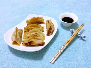 11、冬至美食+韭菜猪肉锅贴,煎制好的锅贴装入盘中兑好的料汁蘸着吃别有一番滋味