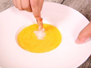 18、粗粮金汤明虾粥,放入准备好的明虾,要注意摆盘,尽量好看,这样会显的很精致,很用心。