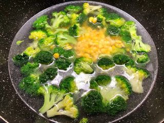 4、虾仁炒西兰花,锅里放入适量水烧开，加入1勺油，一勺盐，少许白糖拌匀，把玉米放入焯5分钟，再把西兰花放入焯30秒，再一起捞起来，用冷水冲凉待用。