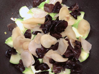 12、西葫芦炒木耳,加入木耳翻炒均匀。